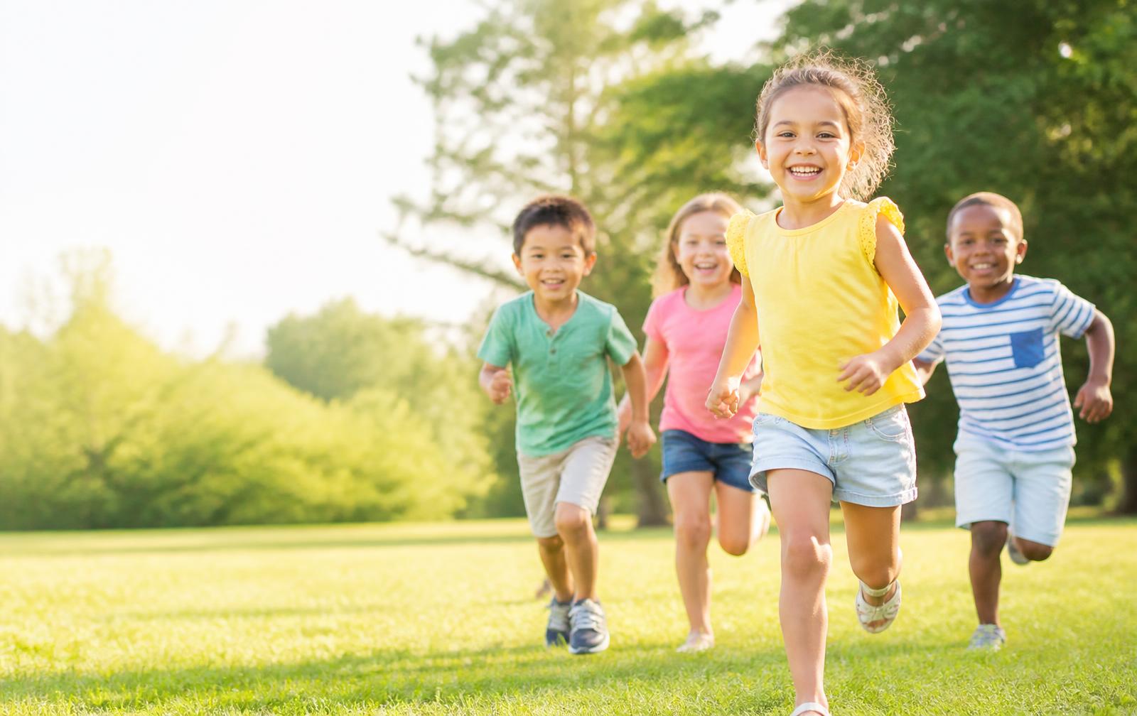 Happy kids running outdoors in colourful Babies Wear clothing